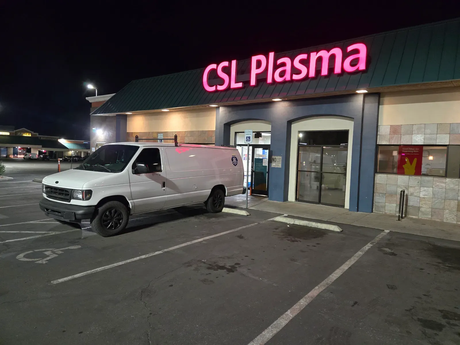 Royal Surface Restore work van parked outside a Las Vegas retail storefront at night before a commercial cleaning job