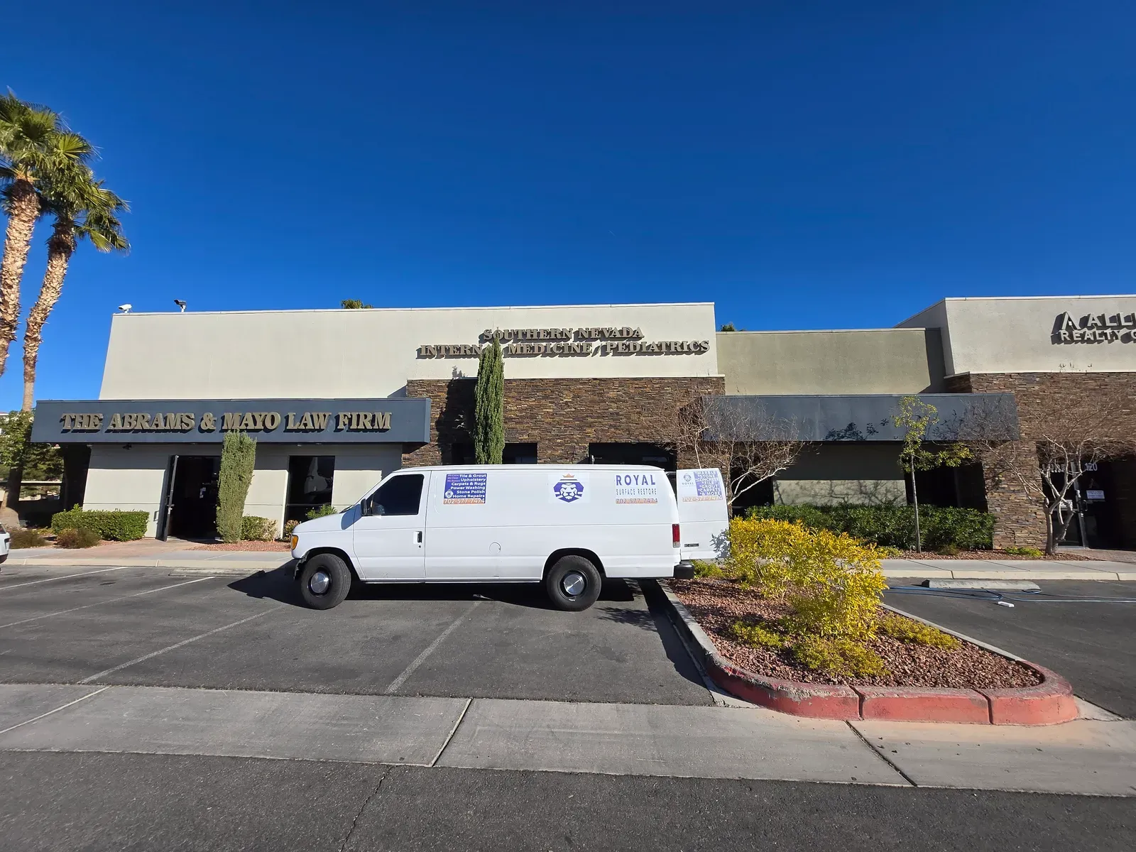 Fully branded Royal Surface Restore van parked outside a Las Vegas medical and office plaza in daylight