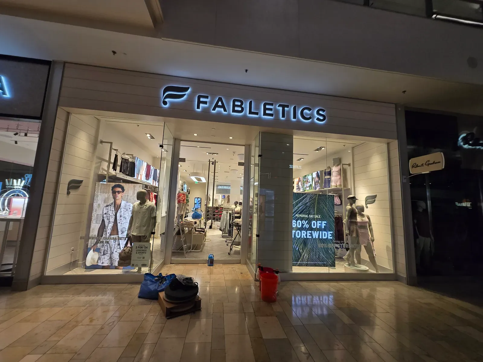 Cleaning equipment set up on the tile floor outside a retail store in a Las Vegas shopping mall