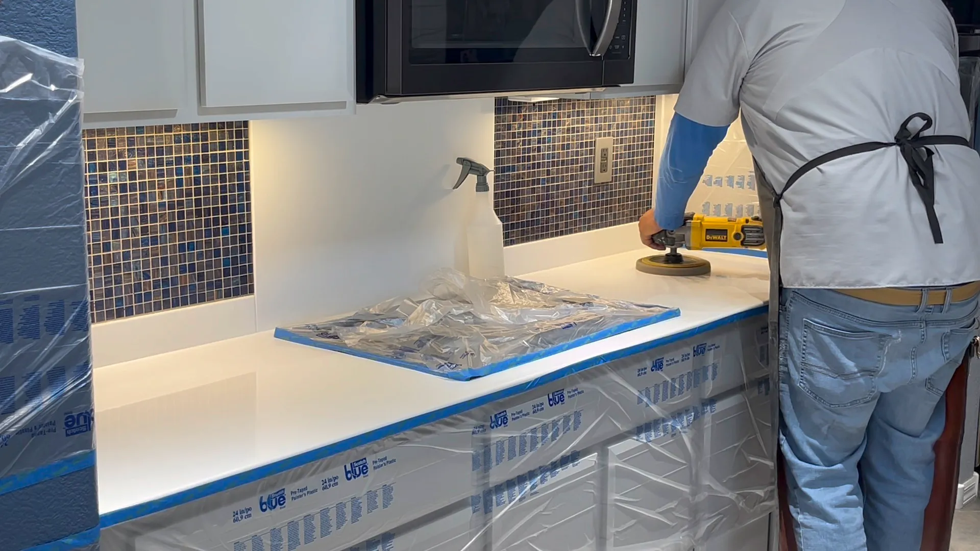 Polishing a white Corian kitchen countertop with a DeWalt orbital in a Las Vegas home