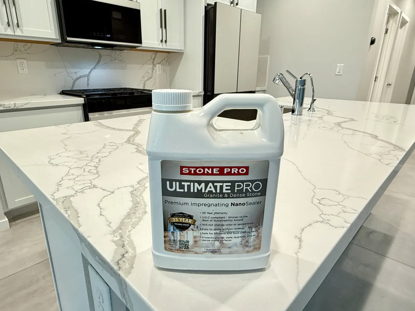 Impregnating stone sealer bottle resting on a newly sealed veined quartz countertop in a Las Vegas kitchen