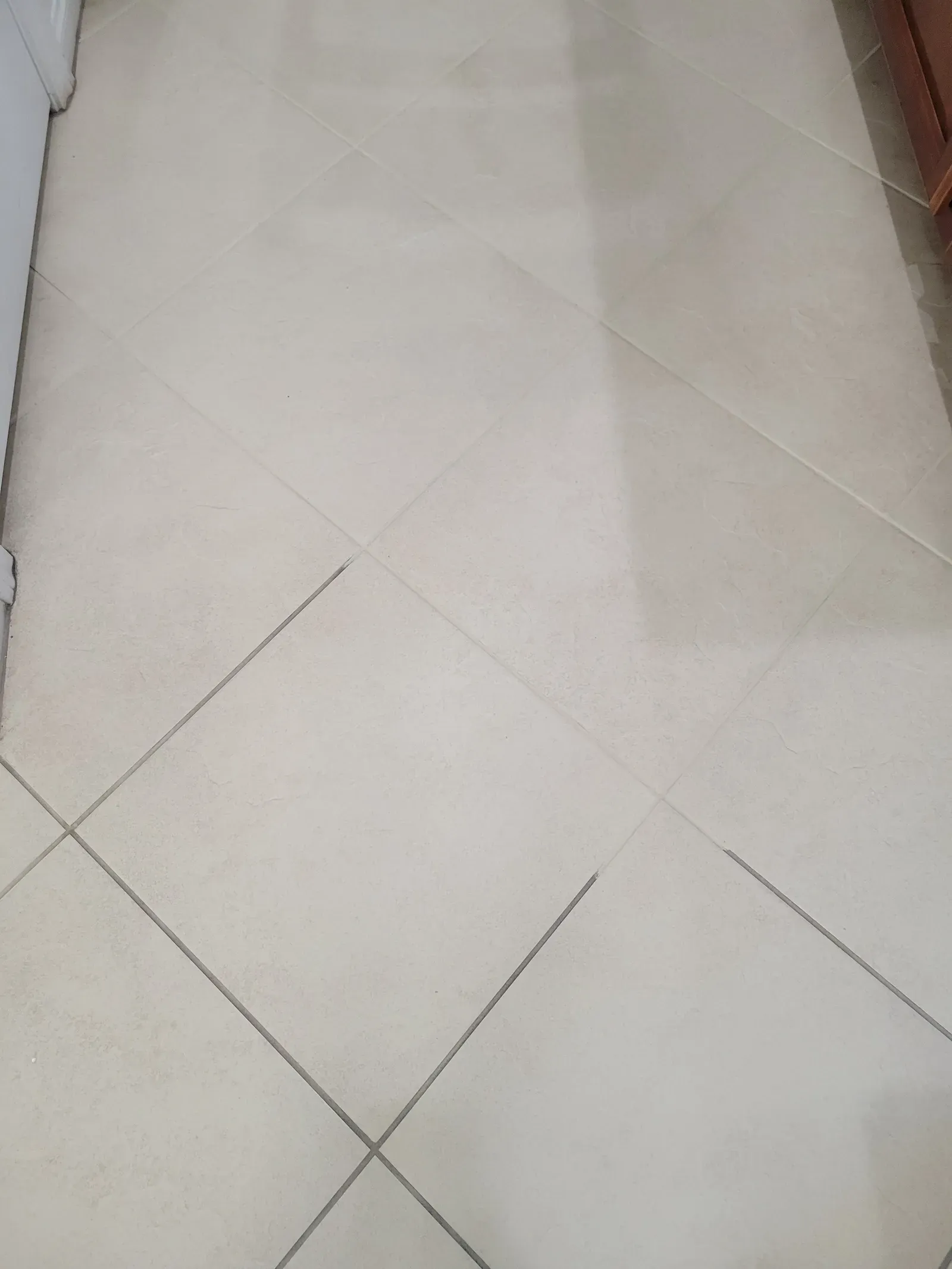 Diagonal cream tile floor with freshly color sealed grout lines in a Las Vegas home