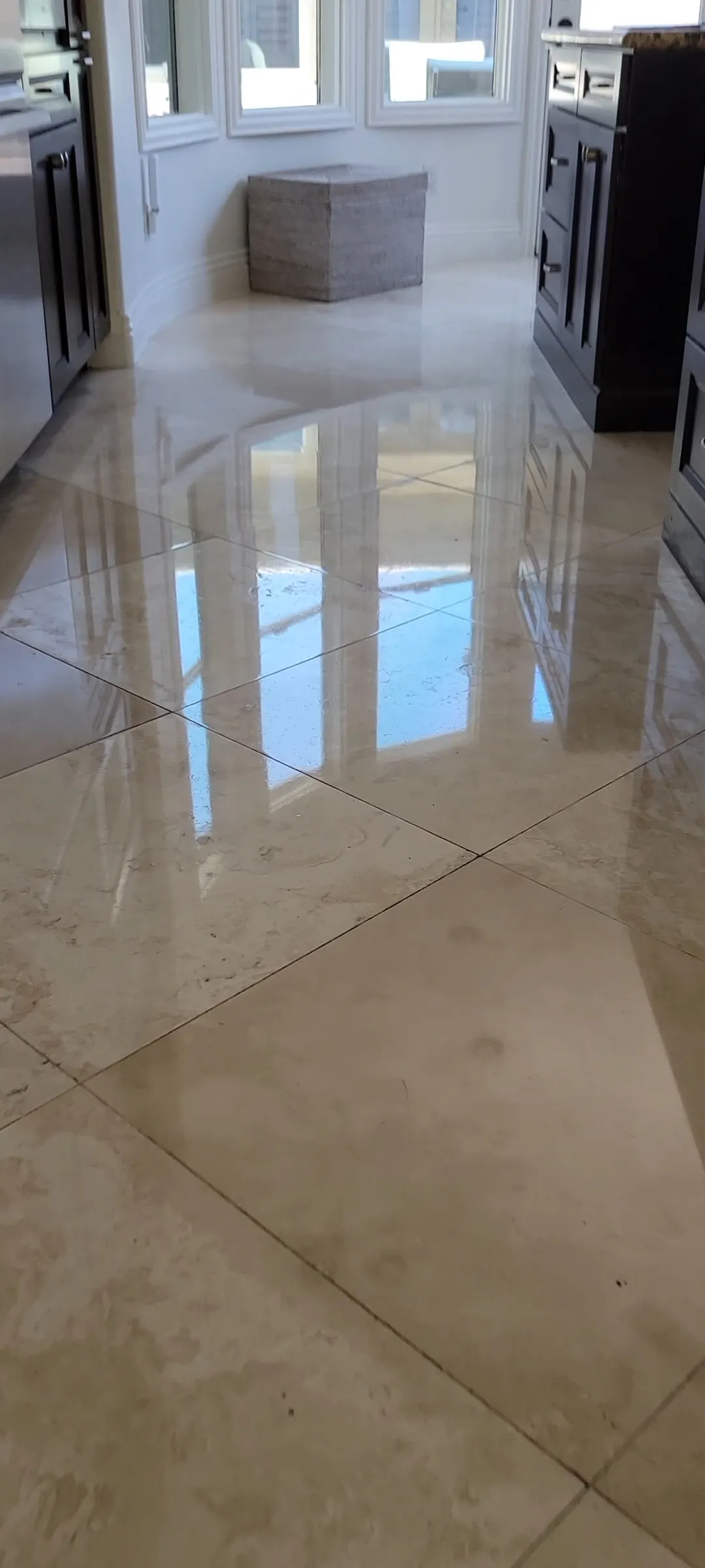 Mirror-polished marble tile floor in a Las Vegas kitchen reflecting natural light