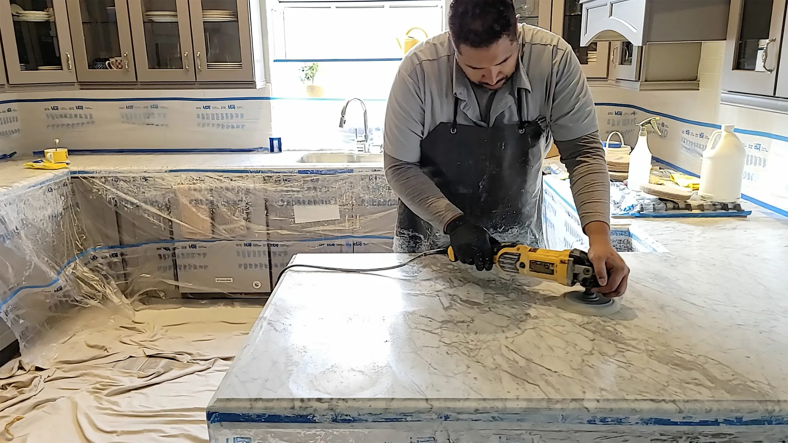 Polishing a marble kitchen island countertop with a diamond pad in a Las Vegas home