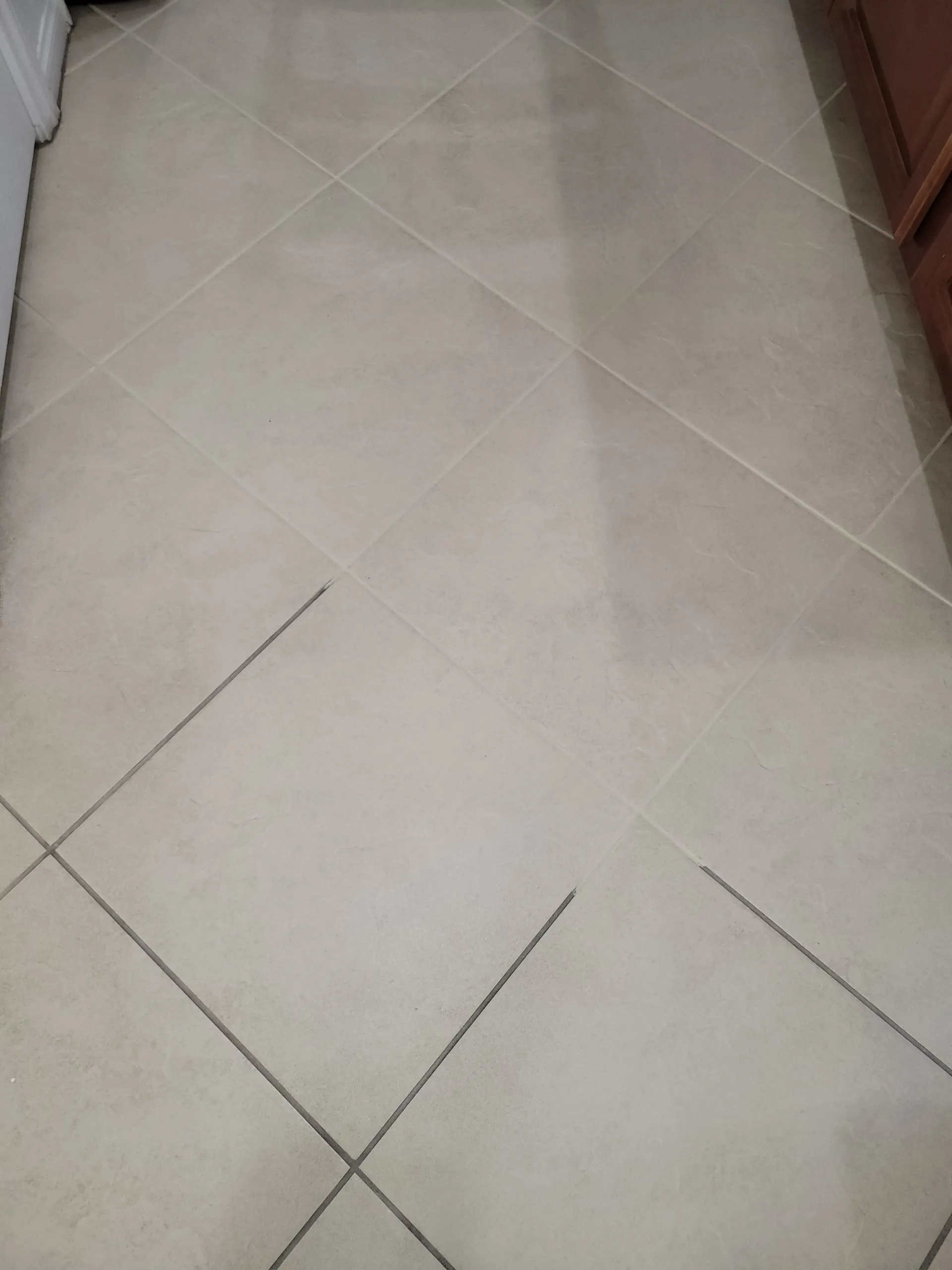 Diagonal cream tile floor fully restored after professional tile and grout cleaning in a Las Vegas kitchen