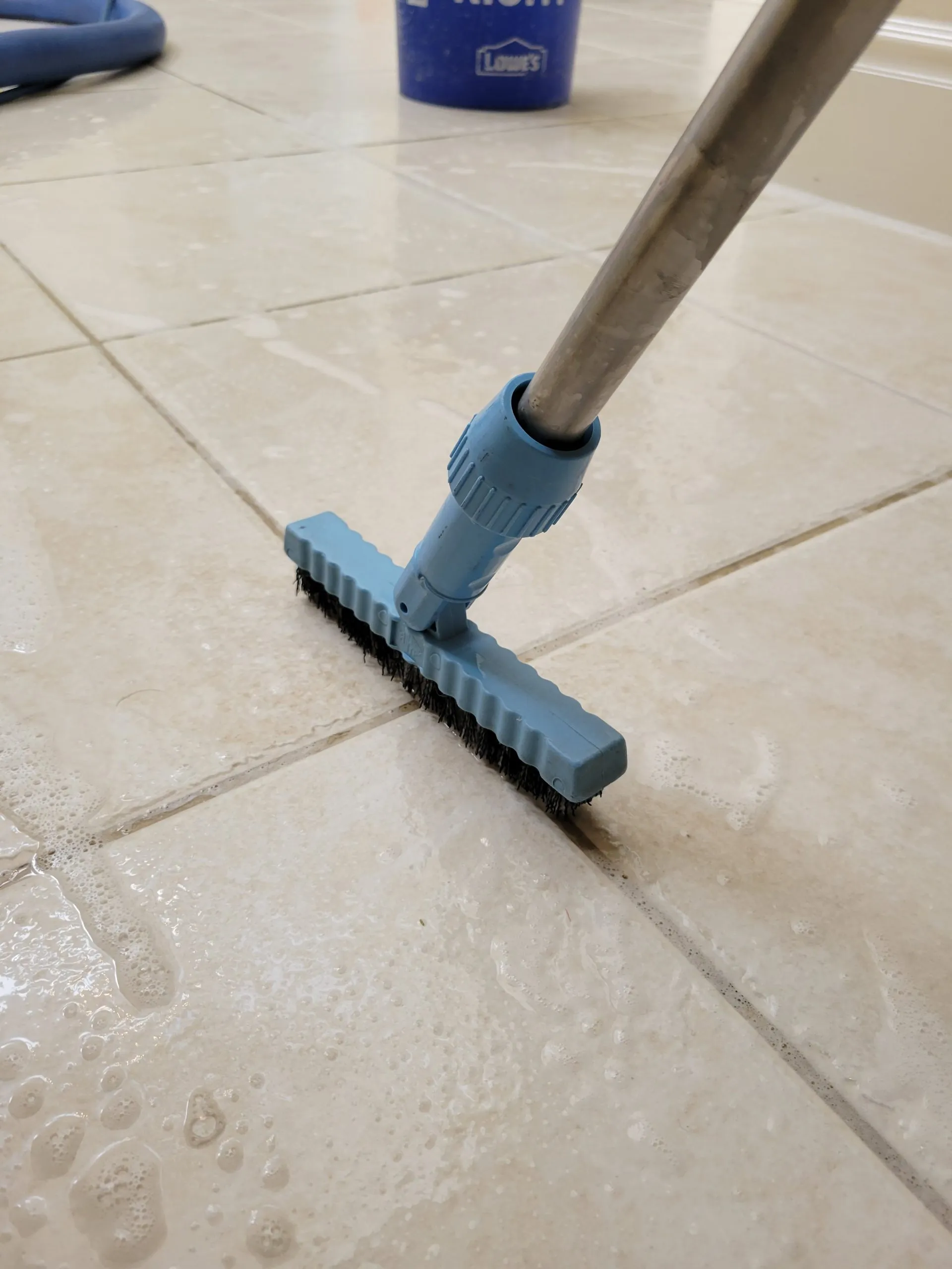 Manual grout scrubbing during a tile and grout cleaning service in a Las Vegas kitchen