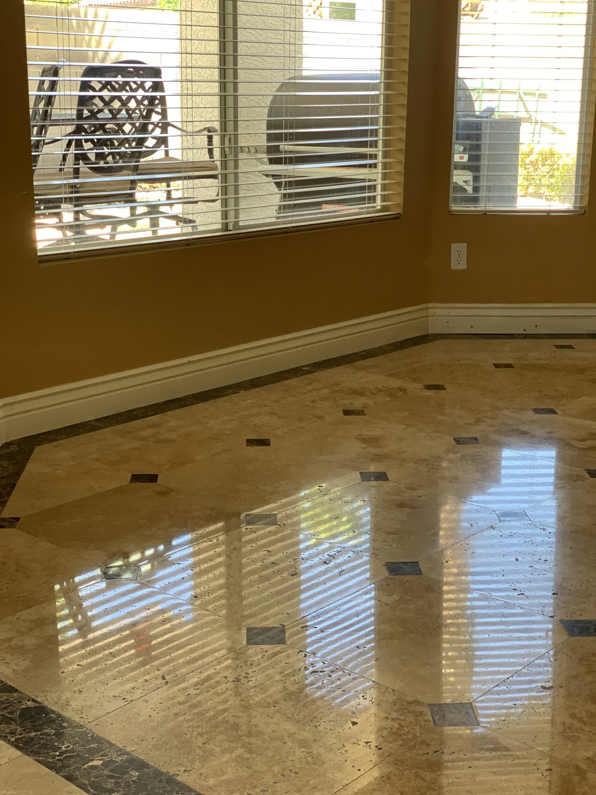 Polished travertine living room floor with mirror reflection in a Las Vegas home